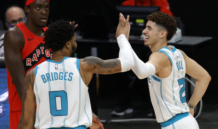LaMelo Ball(2) of the Charlotte Hornets gives Miles Bridges(0) a high five